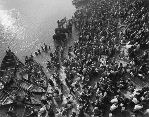 Pilgrims Praying, Elephants and Boats in Holy River, 1993. India. copyright photographer Marilyn Bridges