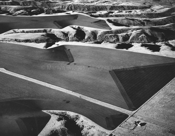 Farmers� Edge, the Badlands, South Dakota 1984. USA Midwest. copyright photographer Marilyn Bridges.